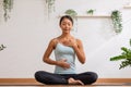 Asian woman doing breathing exercise before practice yoga.Healthy female inhaling and exhaling to deep breath exercise for control