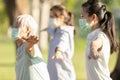 Asian woman is doing exercise activity for the old elderly and child girl,family workout and wearing medical mask outdoor after