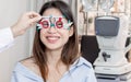 Asian woman doing eyes test in optical lab Royalty Free Stock Photo