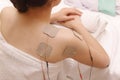 Asian woman is doing massage of electrical -stimulation ( TENs ) Royalty Free Stock Photo