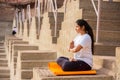 Asian Woman doing outdoor yoga tree pose meditation exercise, mental peace