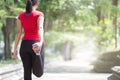 Asian woman doing stretching exercise during outdoor cross train