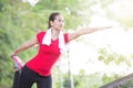 Asian woman doing stretching exercise during outdoor cross train