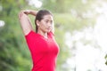 Asian woman doing stretching exercise during outdoor cross train