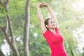 Asian woman doing stretching exercise during outdoor cross train