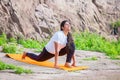 Asian Woman doing yoga stretching exercise outdoor