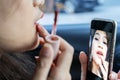 An Asian woman, she is dressing up in her car Royalty Free Stock Photo