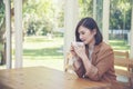 Asian Woman drink black coffee hand holding cup at green garden cafe. Young woman smile face love drink coffee. Beauty woman Royalty Free Stock Photo