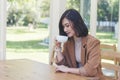 Asian Woman drink black coffee hand holding cup at green garden cafe. Young woman smile face love drink coffee. Beauty woman Royalty Free Stock Photo