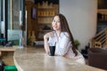 Asian woman drink ice coffee sitting cafe shop Royalty Free Stock Photo