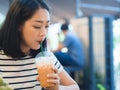 Woman drink iced coffee in the cafe.