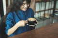 Asian woman drinking coffee in shop Royalty Free Stock Photo