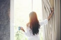 Asian women drinking coffee and wake up in her bed fully rested Royalty Free Stock Photo