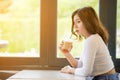 Asian woman drinking cold coffee