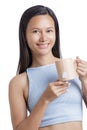 Asian Woman drinking a Healthy Tan Mug of Hot Tea Royalty Free Stock Photo