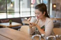 Asian woman drinking hot coffee at coffee shop Royalty Free Stock Photo
