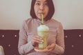 Asian woman drinking ice green tea matcha in modern restaurant Royalty Free Stock Photo