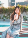 Asian woman drinking Milkshake on a summer beach with hot sun shining for Vacation relaxation concept Royalty Free Stock Photo