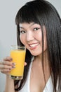 Asian woman drinking orange juice Royalty Free Stock Photo
