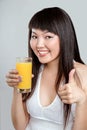 Asian woman drinking orange juice Royalty Free Stock Photo