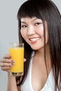 Asian woman drinking orange juice Royalty Free Stock Photo