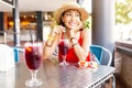 Asian woman drinking sangria, traditional spanish sort of fruit wine in outdoor restaurant Royalty Free Stock Photo