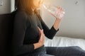 Asian woman drinking water having or symptomatic reflux acids Royalty Free Stock Photo