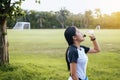 Woman drinking water after running exercise at the garden in sunset Royalty Free Stock Photo