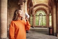 Asian woman drinks drinks healthy mineral thermal water in one of the famous European medical and therapeutic resorts Royalty Free Stock Photo