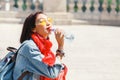 Asian woman drinks water from plastic bottle at city street Royalty Free Stock Photo