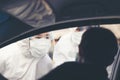 Asian Woman Drive Thru Covid-19 Testing With PPE Medical Staff, COVID testing temp while checking in cars Royalty Free Stock Photo