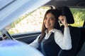 Asian woman driver smiling and showing new car keys. Royalty Free Stock Photo