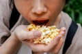 Asian woman easting popcorn full hand Royalty Free Stock Photo