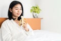 Asian woman eating banana healthy eating, breakfast in bed Royalty Free Stock Photo