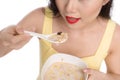 Asian woman eating bowl of cereal or muesli for breakfast Royalty Free Stock Photo