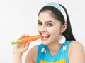 Asian woman eating a carrot Royalty Free Stock Photo