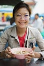 Asian woman eating crepe congree congree