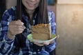 Asian woman eating diet cake.
