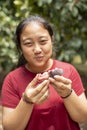 Asian woman eating fresh mangosteen in fruit plantation field