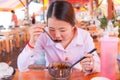 Asian woman eating noodle