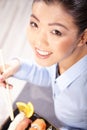 Asian woman eating sushi. Shallow depth of field, focu