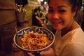 Asian Girl with a Bowl of Pad Thai at a Thai Restaurant in New York City