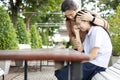 Asian woman is embracing comforting and caring for sad daughter in the school,depressed child girl sitting crying,loving mother Royalty Free Stock Photo