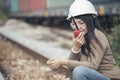 Asian woman engineer or construction worker wearing safety hat helmet and holding portable radio at railway project. Civil Royalty Free Stock Photo