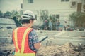 Asian women engineering holds a tablet for use in the inspection of construction sites for accuracy and in accordance with the pla