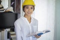 Asian women engineering inspecting and working and holding blueprints at home office Royalty Free Stock Photo