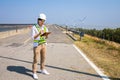 Asian woman engineers are checking and submitting reports outdoors on site power plant energy