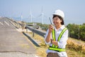 Asian woman engineers are using walkie-talkies outdoors on site power plant energy