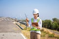 Asian woman engineers are using walkie-talkies and tablet outdoors on site power plant energy