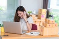 Asian woman enjoy herself while using internet on laptop and ph Royalty Free Stock Photo